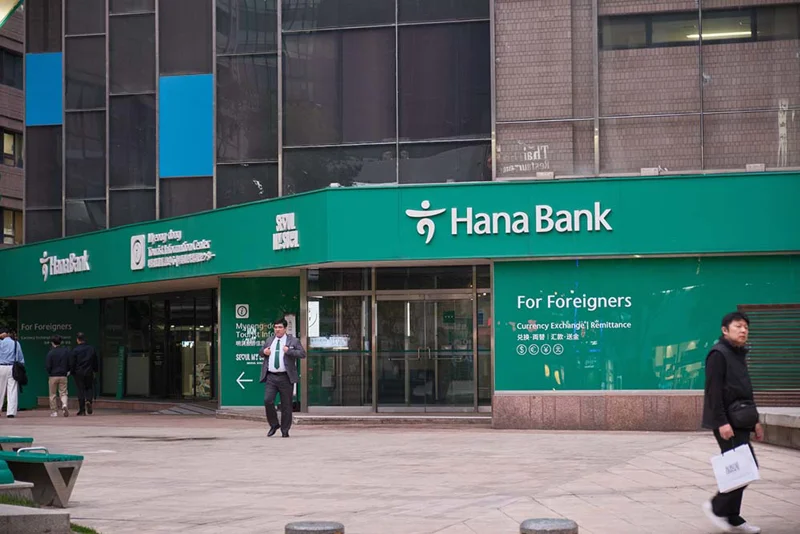 people walking past a bank